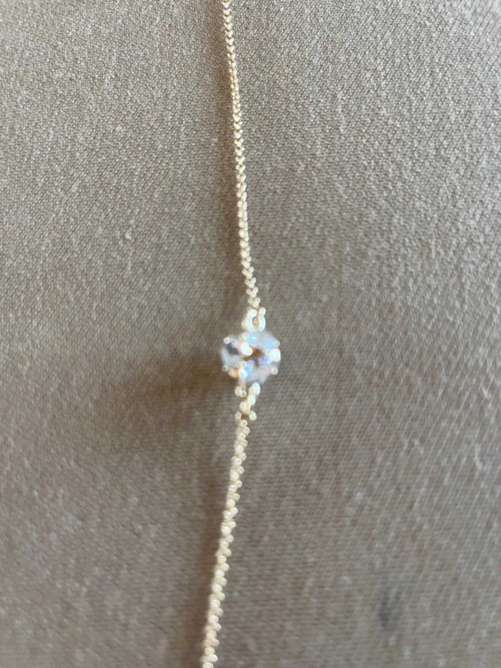 Kate Spade long golden necklace with crystal beads.